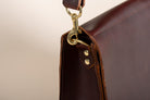 Close-up of Indigo Laine The Satchel in Tobacco, showing removable strap