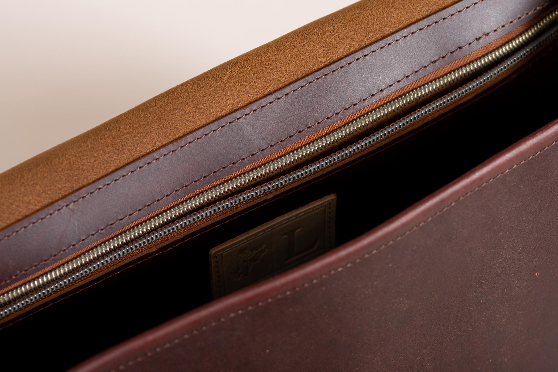 Close-up of Indigo Laine The Satchel in Tobacco, showing interior zippered pocket