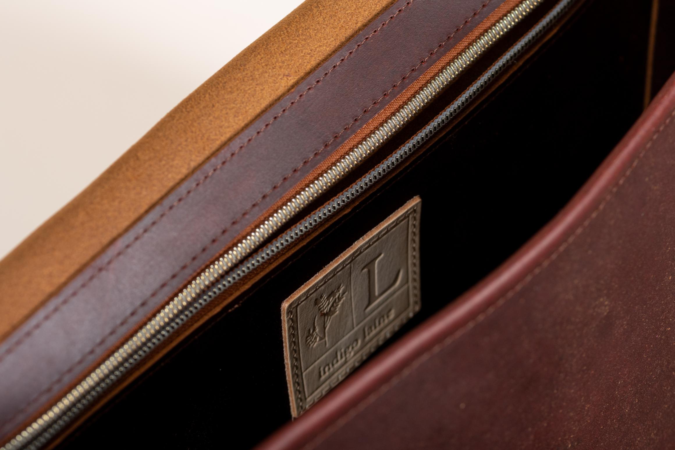 Close-up of Indigo Laine The Satchel in Tobacco, showing interior zippered pocket 