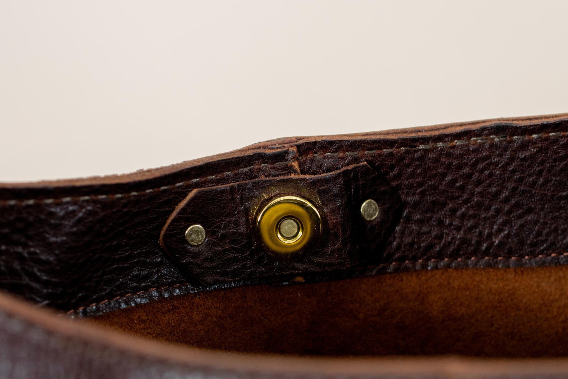Leather bag brass turn-lock closure detail