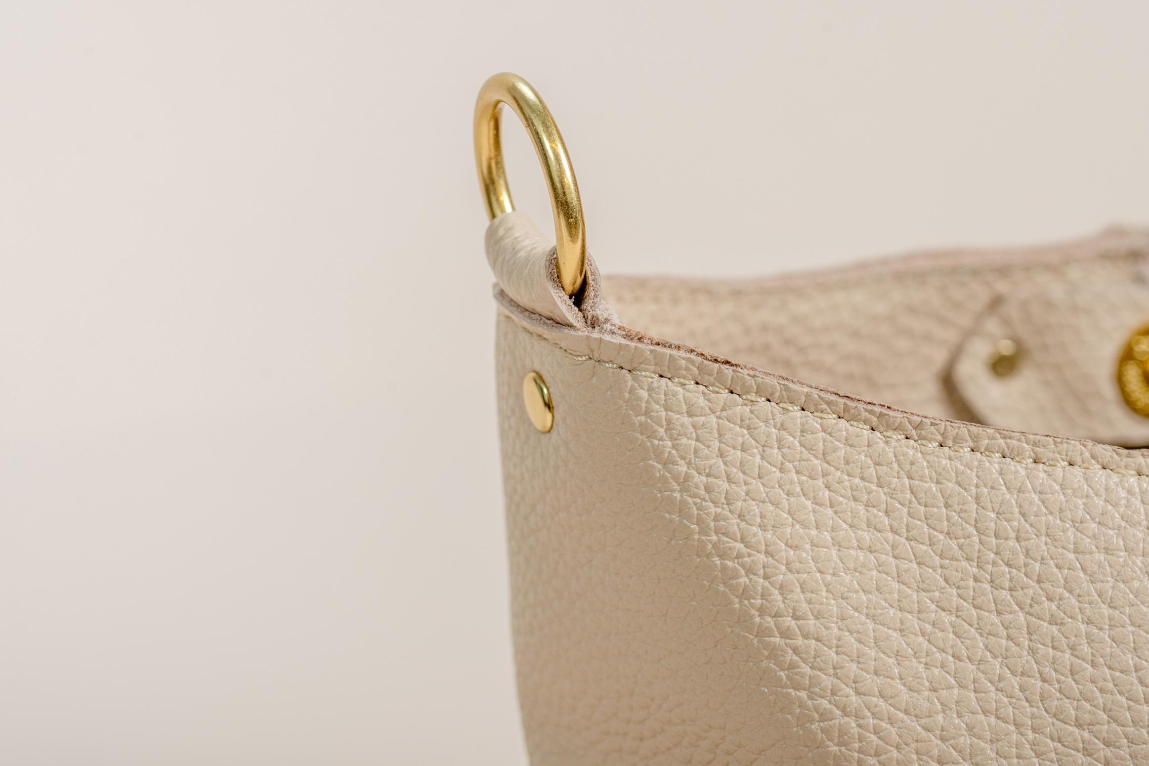 Cream leather bag brass O-ring hardware detail