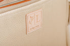 Close-up of Indigo Laine The Laptop Sleeve in Bone, showing the Indigo Laine logo
