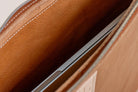 Close-up of Indigo Laine The Laptop Sleeve in Camel, showing the interior fitting a laptop