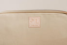 Close-up of Indigo Laine The Laptop Sleeve in Bone, showing the Indigo Laine log and zipper