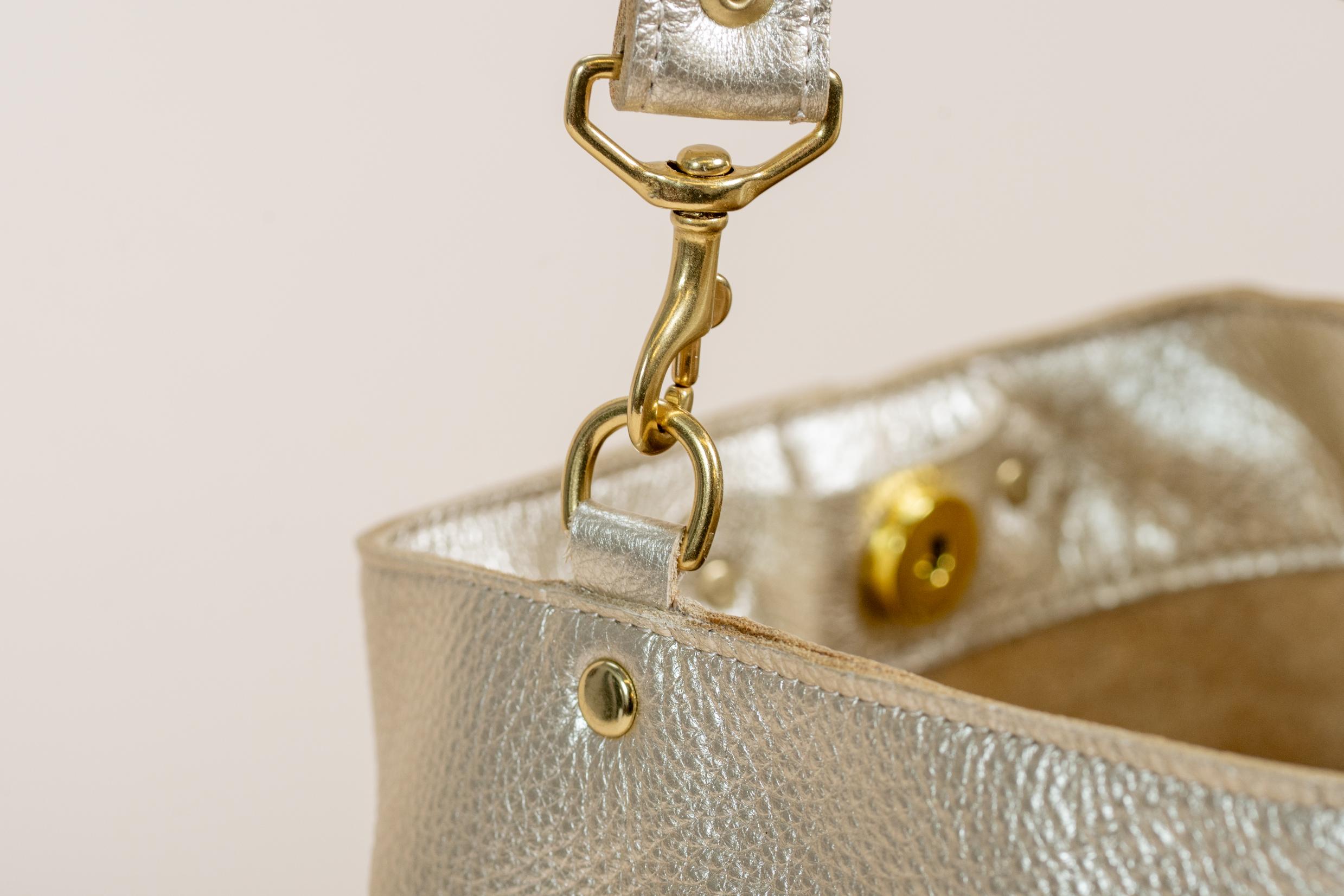Indigo Laine Scout metallic gold bag brass hardware and strap clasp detail