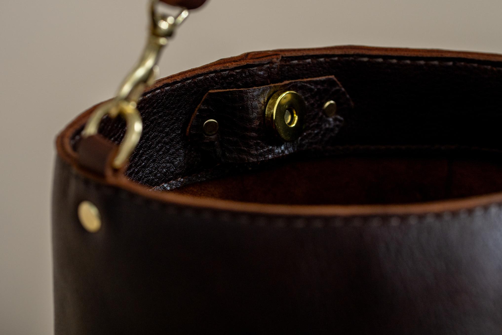 Indigo Laine Scout bucket bag brass hardware and strap clasp detail