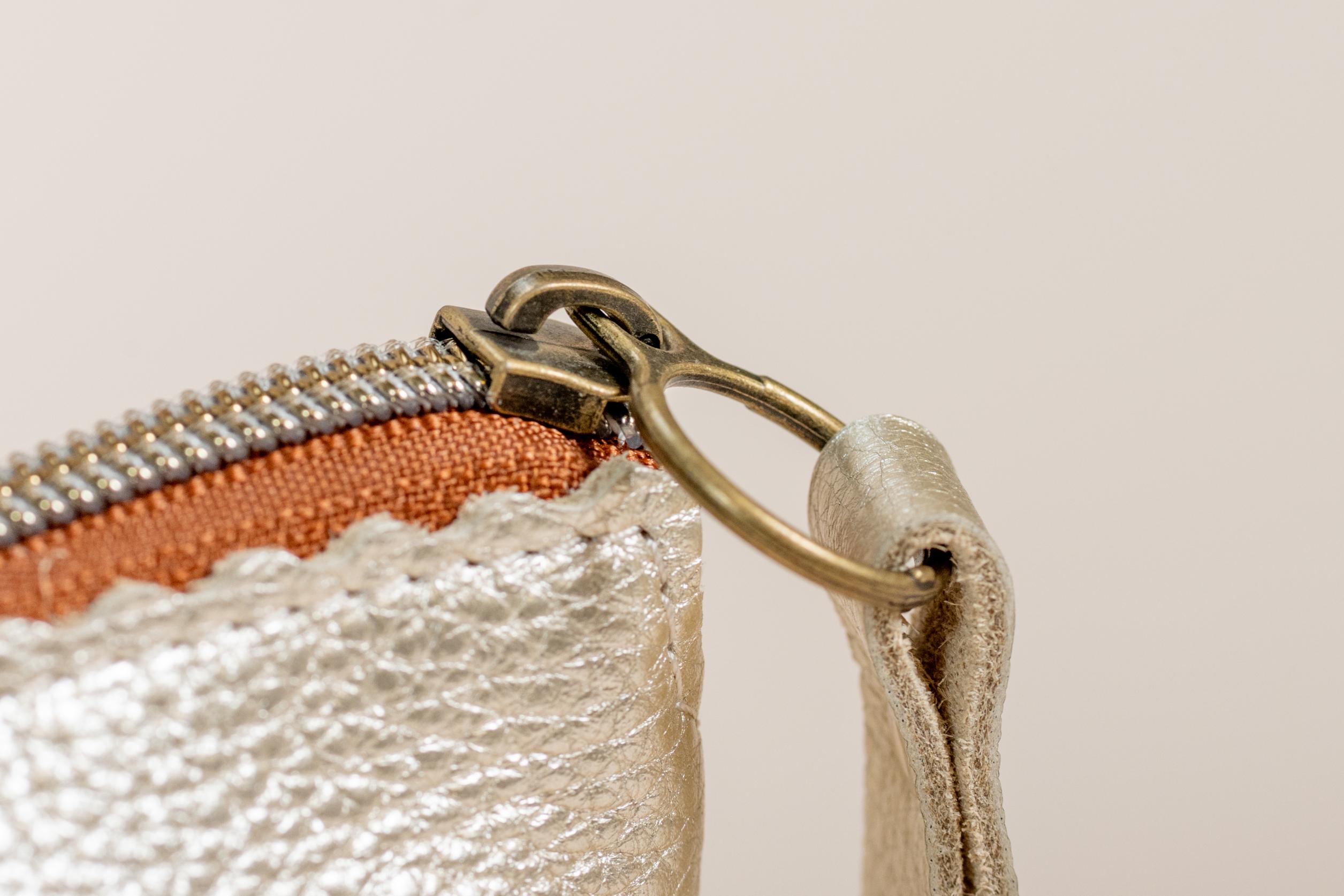 Close-up of The Sloane's clasp and wrist strap in champagne