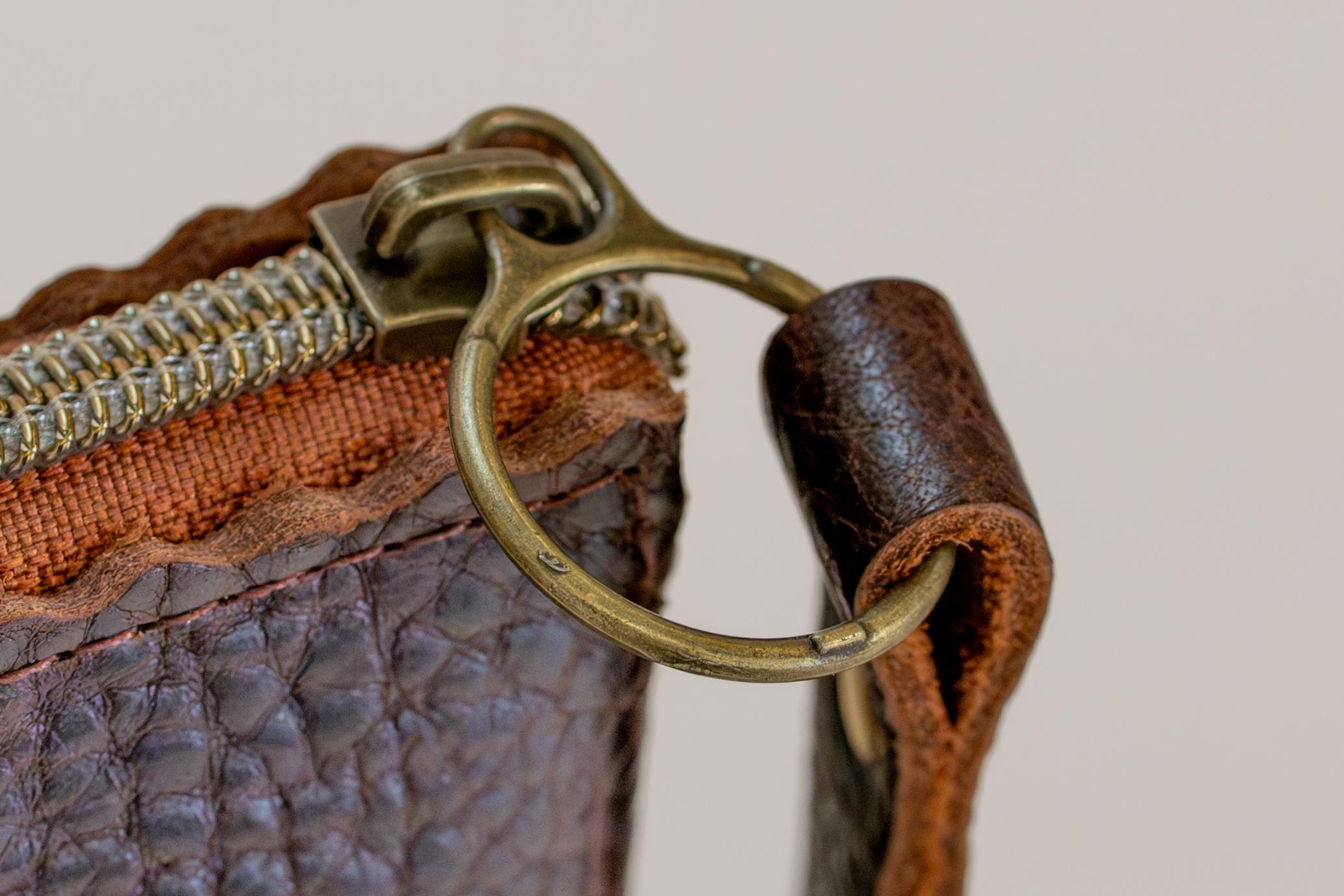 Close-up of The Sloane's clasp and wrist strap in dark brown.