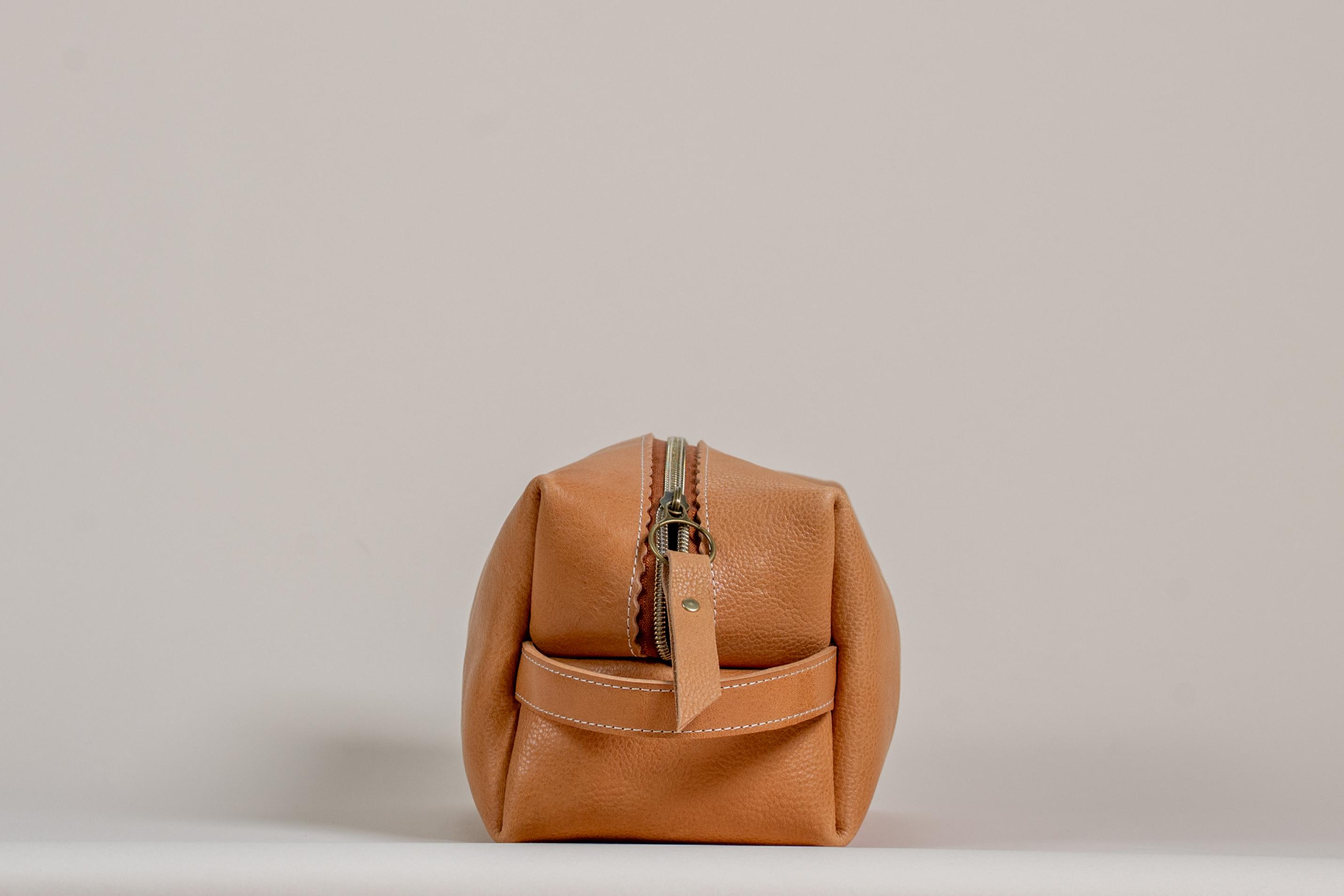 Indigo Laine The Toiletry Kit in Camel, showing the scallop design and zipper