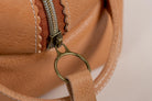 Close-up of Indigo Laine The Toiletry Kit in Camel, showing the scallop design and strong leather handle