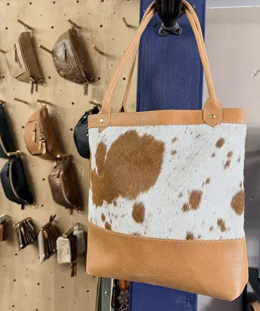 Cowhide and tan leather tote bag